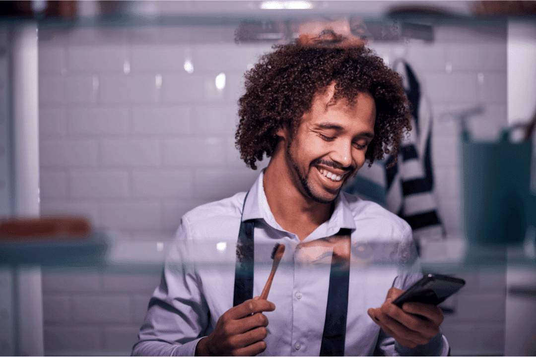 young man brushing teeth in hotel room business travel